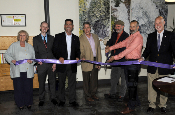 A group gather inside the new DragonSearch building for a ribbon cutting
