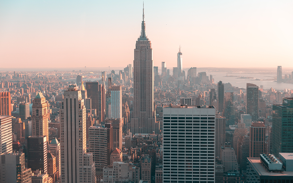 skyscraper view of the empire state building and new york city skyline sunset