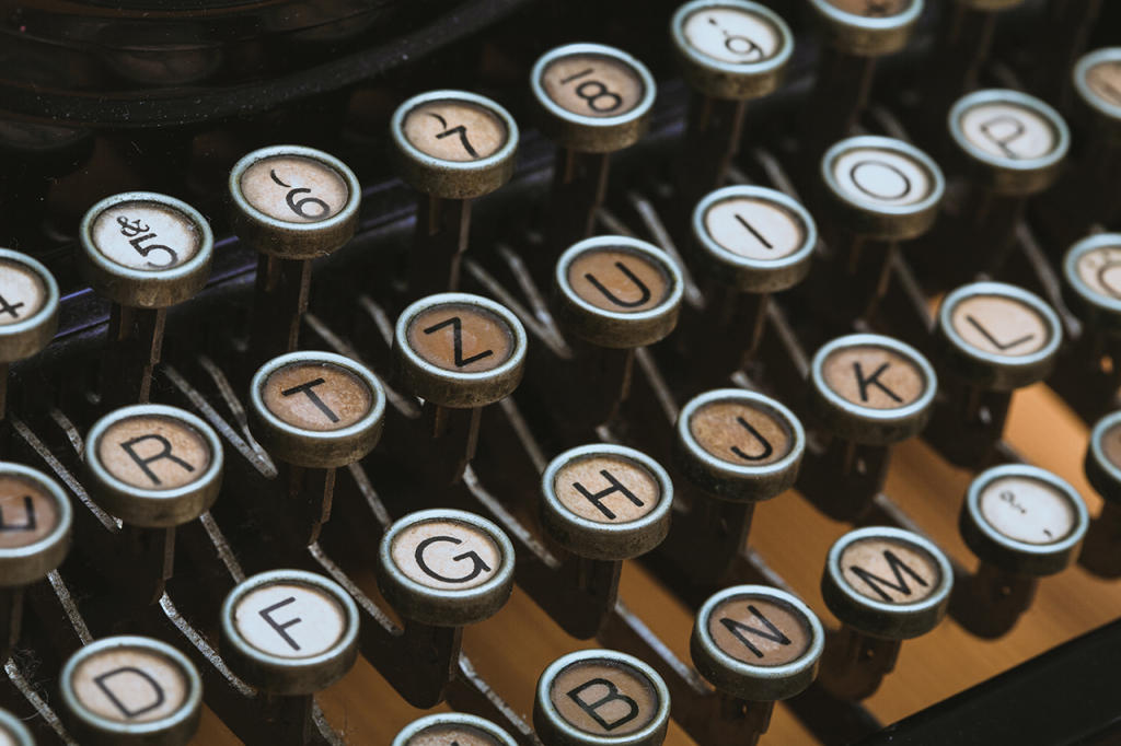 upclose photo of old fashioned typewriter keys - Dragon360